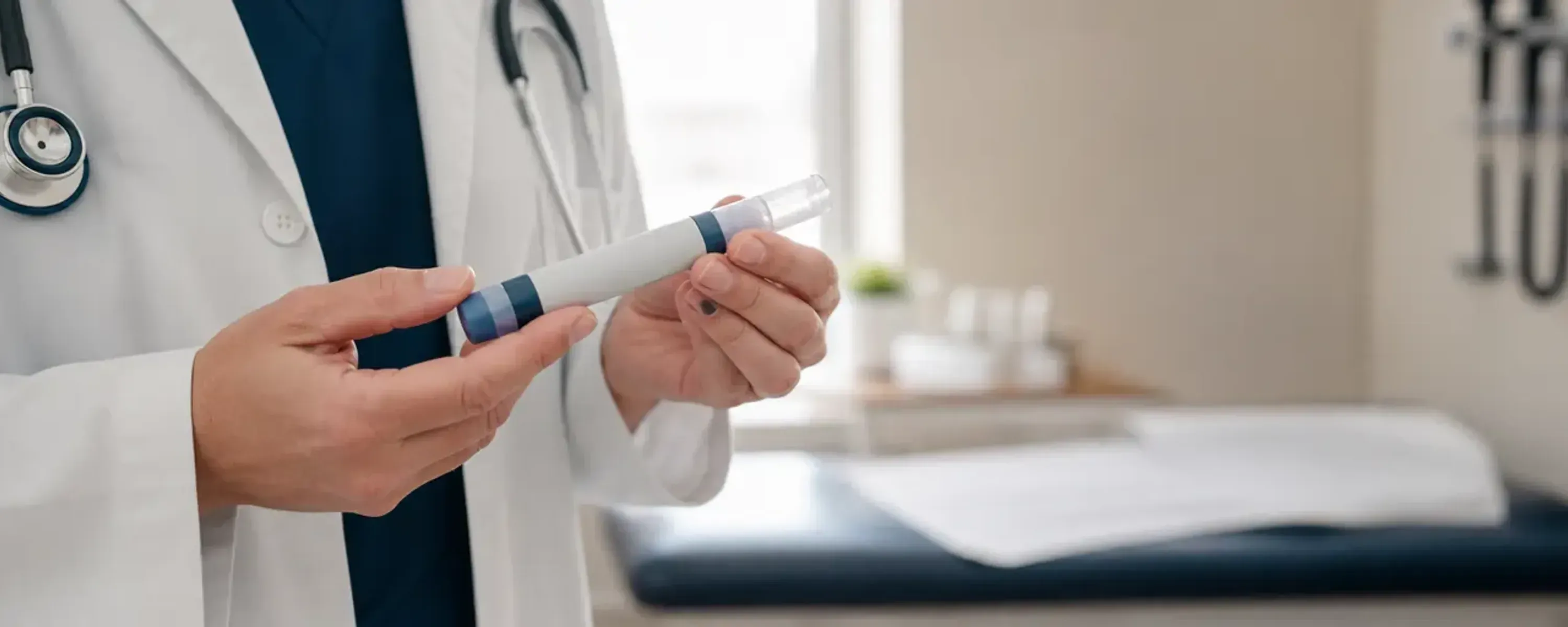 Clinician holding a generic prefilled subcutaneous injection pen in a modern clinic setting, illustrating the practical picture of semaglutide weight-loss treatment.